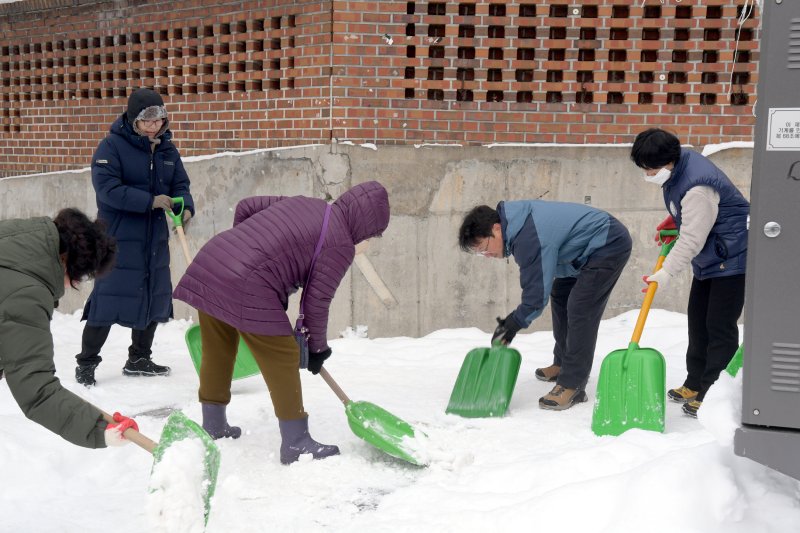 강기정 광주시장이 북구 문흥1동 일원에서 직원, 자원봉사자 등과 내 집 앞 눈 치우기에 참여해 도로 위 제설 작업을 하고 있다. ⓒ사진 광주시 제공, 뉴스1